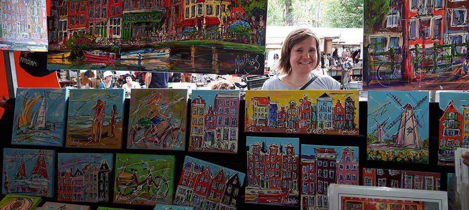 Buying art at a market in the Jordaan